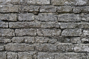 Old grey color grungy brick wall texture.