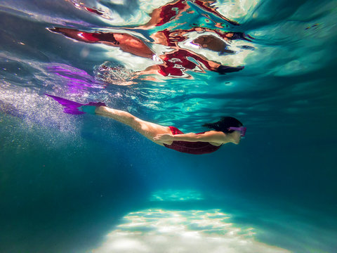 Girl swimming in a swimming pool
