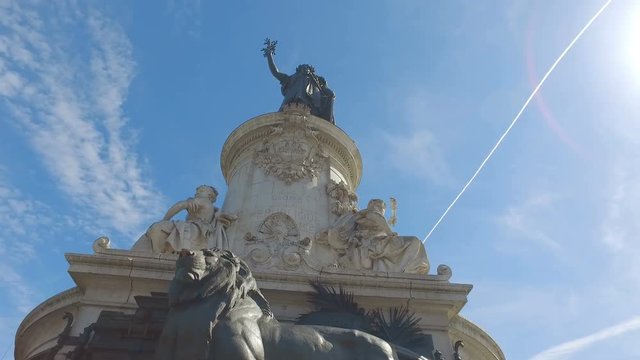 Bronze statue of Marianne holding an olive branch in her right hand Place de la Republique Paris France. hyperlapse video