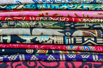 Assortment of colorful sarongs for sale in local market, Island Bali, Ubud, Indonesia. Closeup