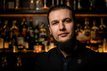 Fototapeta premium Portrait of young male bartender in bar