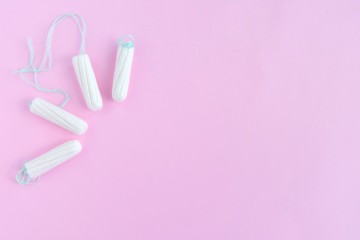 Cotton Hygienic tampons for women period days with selective focus on blurred pink background with empty space for text. Personal protection tampon for menstruated period. Females healthcare 