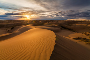 Naklejka na ściany i meble Beautiful desert landscape with a colorful sunset. Desert background.