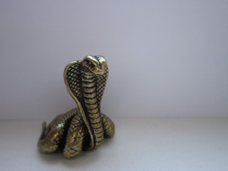  Snake king cobra metal brass on a white background.