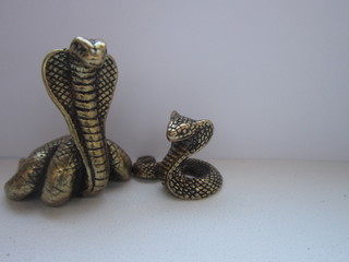  Snake king cobra metal brass on a white background.