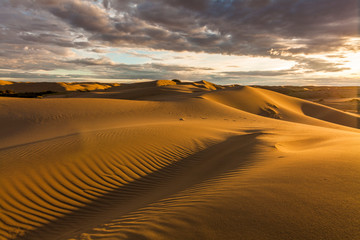 Naklejka na ściany i meble Beautiful desert landscape with a colorful sunset. Desert background.