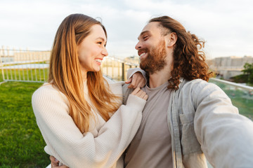 Beautiful young couple in love walking outd at the park