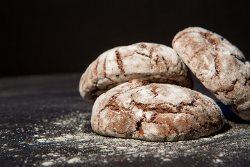 Stacked chocolate chip cookies on black background, sweet dessert, selective focus.