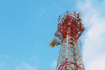 Wireless Communication Antenna Transmitter. Telecommunication tower with antennas on blue sky...