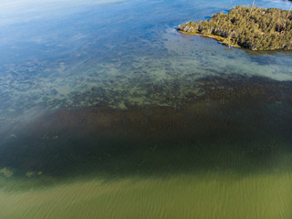 Drone picture of lake and some rock with one island