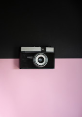 Film retro camera on a black and pink background 7