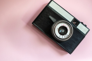 Film retro camera on a pink background 1