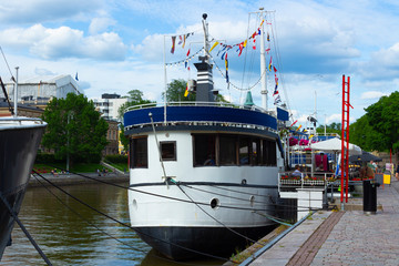 An old vintage ship laid up at the pier of the embankment of the Auraioki River in the city of Turko Abo in Finland.
