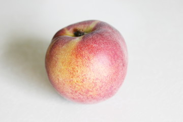 Peaches lying on the table on a white background