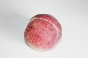 Peaches lying on the table on a white background