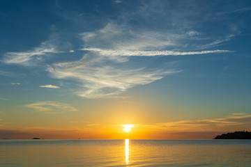 Fototapeta na wymiar Colorful sunset over calm sea water near tropical beach. Summer vacation concept. Island Phangan, Thailand