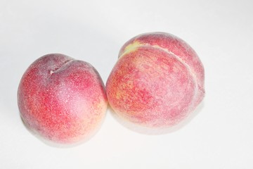 Peaches lying on the table on a white background