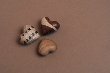 3 Wooden hearts on brown background