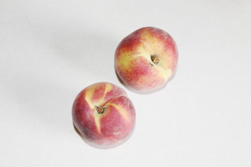 Peaches lying on the table on a white background