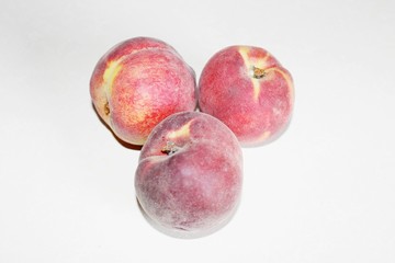Peaches lying on the table on a white background