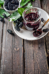Mulberry Chutney or Jam, with fresh Mulberries, wooden rustic background