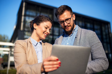 Business people looking at tablet device