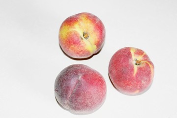 Peaches lying on the table on a white background