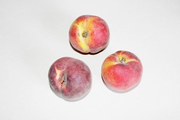 Peaches lying on the table on a white background
