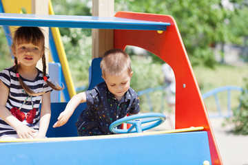 Two happy children playing at playground.Concept of summer,childhood and leisure