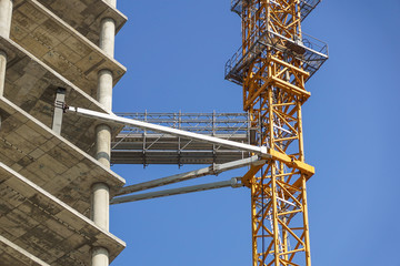 Fototapeta na wymiar crane anchored to building on site under construction