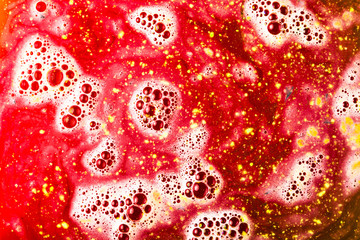 Dissolve of red bath bomb with bubble background