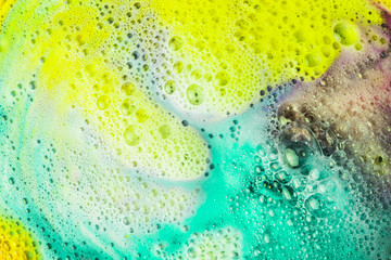 Foam and bubbles form on the surface of bath bomb dissolve in water