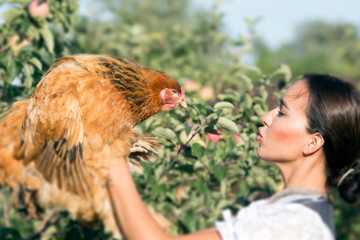 girl with chicken in hand