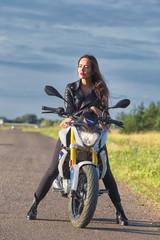 Fototapeta na wymiar portrait girl sitting on motorcycle