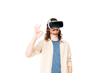 young man with VR headset showing Ok sign at camera isolated on white