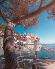 A girl looking at Manarola at 5 Terre in Liguria, Italy
