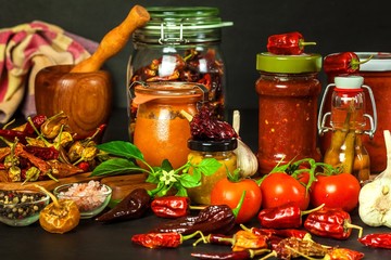 Homemade chili sauce. Spicy food. Chili peppers on black background. Bhutjolokia hot chilli pepper. Healthy food.