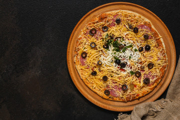 pizza, raw ingredients (frozen dough, olives, meat, sausages, tomato sauce, cheese). Top view. copy space