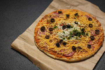 pizza, raw ingredients (frozen dough, olives, meat, sausages, tomato sauce, cheese). Top view. copy space
