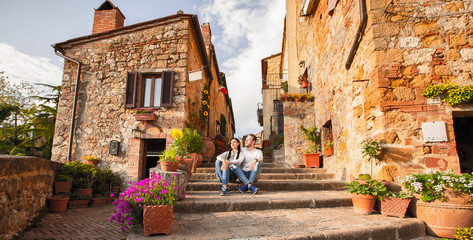 Beautiful Tourist Couple In Love Enjoying Rest In The Old City At Sunset - obrazy, fototapety, plakaty