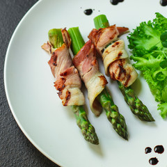 Asparagus in bacon, delicious grilled vegetables with meat wrapped. food background. top view. copy space