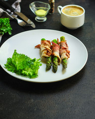 Asparagus in bacon, delicious grilled vegetables with meat wrapped. food background. top view. copy space