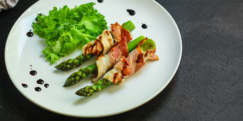 Asparagus in bacon, delicious grilled vegetables with meat wrapped. food background. top view. copy space