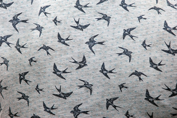 texture photo of a swallow on a fabric pattern