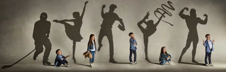 Wall murals Daycare Childhood and dream about big and famous future. Conceptual image with boy and girl and shadows of fit athlete, hockey player, bodybuilder, ballerina. Creative collage made of 2 models.