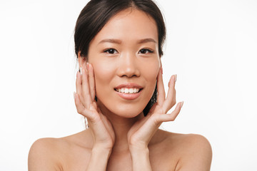 Beautiful positive asian young pretty woman with healthy skin posing isolated over white wall background.