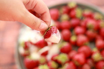 strawberries in cream on the background of ripe, juicy strawberries with cream