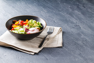 Vegan buddha bowl. Healthy vegetarian salad with cherry tomatoes, cucumber, radish,, avocado and lettuce.
