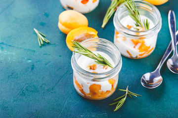 Natural yogurt with pieces of apricots and rosemary