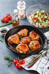 Delicious fried chicken thighs in a cast iron skillet